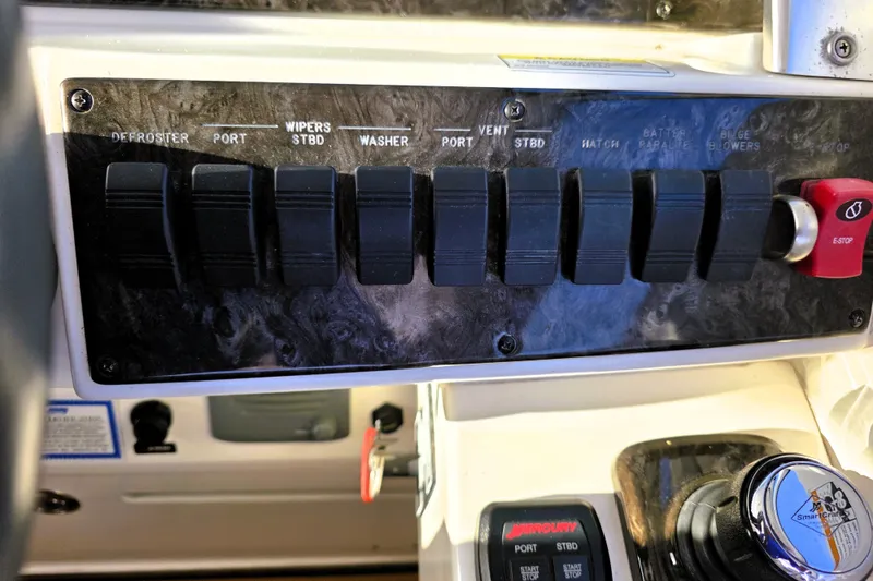 Slide: The Image of Control panel of a 2012 Sea Ray 410 Sundancer boat with labeled switches. - 16