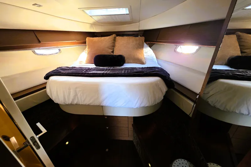 Slide: The Image of Luxurious cabin interior of 2012 Sea Ray 410 Sundancer yacht with cozy bedding. - 26
