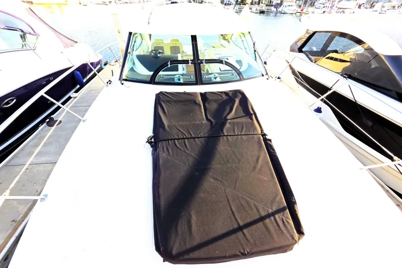 Slide: The Image of 2012 Sea Ray 410 Sundancer yacht docked at marina, covered deck, sunny day. - 37