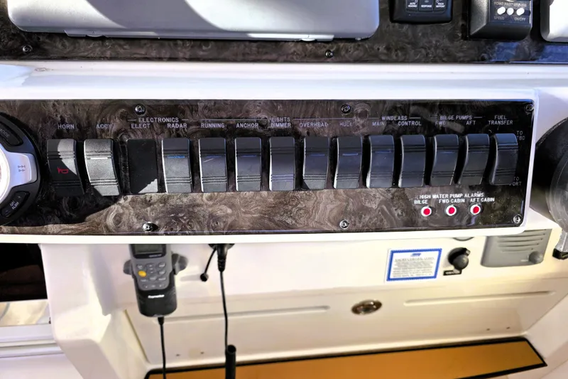 Slide: The Image of Control panel of a 2012 Sea Ray 410 Sundancer boat with labeled switches. - 15