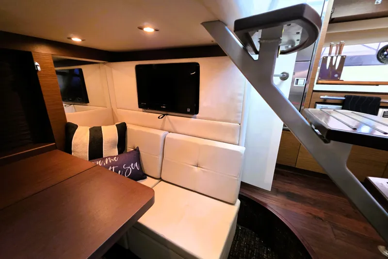 Slide: The Image of Luxurious interior of 2012 Sea Ray 410 Sundancer yacht with cozy seating and TV. - 31