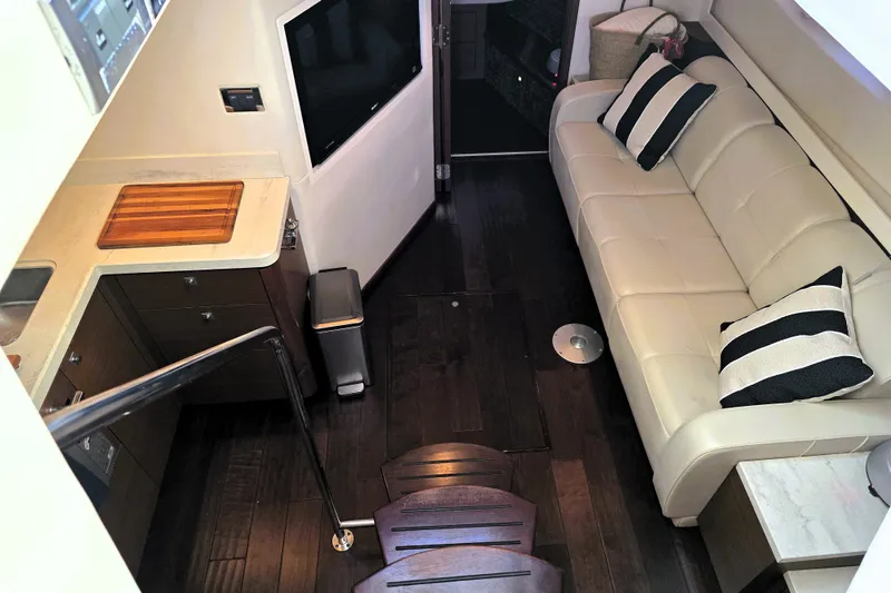 Slide: The Image of Interior of 2012 Sea Ray 410 Sundancer yacht with modern kitchen and cozy seating area. - 17