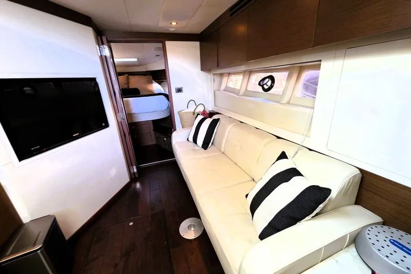 Slide: The Image of Luxurious interior of 2012 Sea Ray 410 Sundancer with sofa and striped pillows. - 23