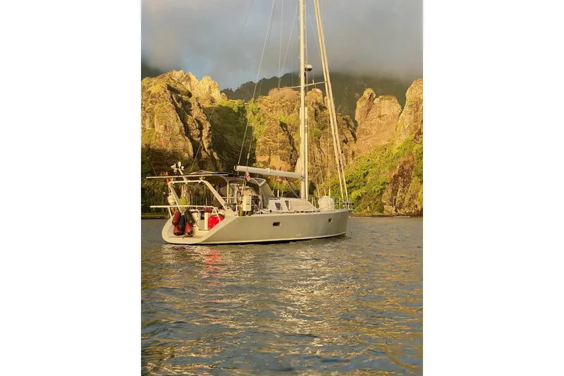 Slide: The Image of Sailing yacht Garcia 48 Raised Salon, 2000 model, anchored near rocky cliffs at sunset. - 83