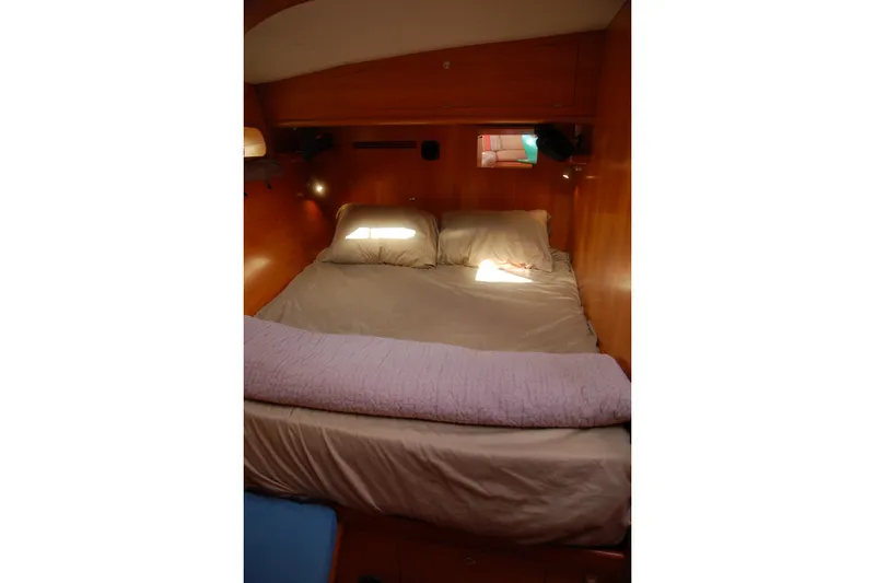 Slide: The Image of Cozy bedroom interior of 2000 Garcia 48 Raised Salon yacht with wooden paneling. - 70