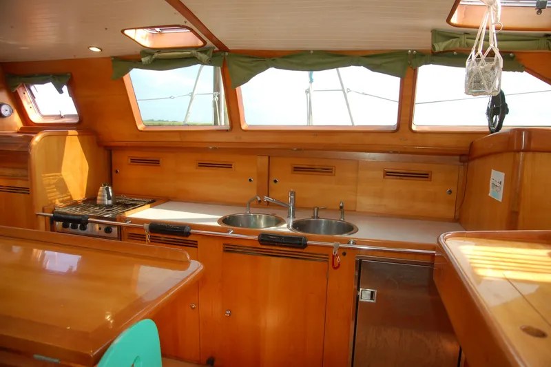 Slide: The Image of Interior of 2000 Garcia 48 Raised Salon yacht with wooden cabinetry and kitchen amenities. - 57
