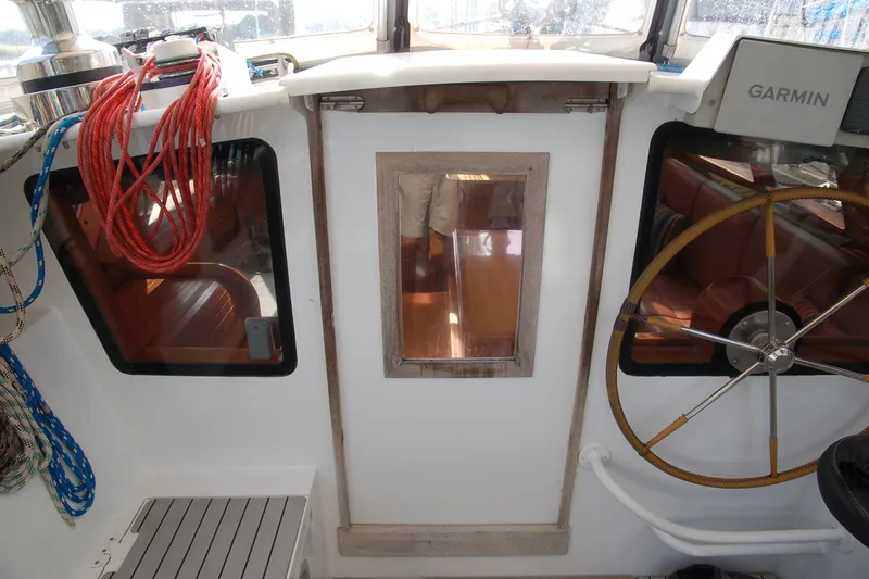 Slide: The Image of Cockpit of 2000 Garcia 48 Raised Salon yacht with ropes and steering wheel. - 46