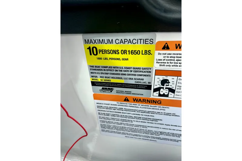 Slide: The Image of 2022 Scarab 215 ID capacity label, maximum 10 persons or 1650 lbs, safety warnings included. - 29