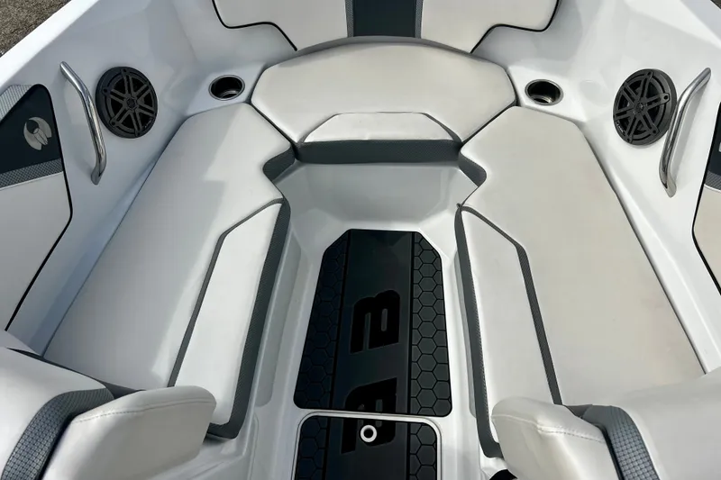 Slide: The Image of Interior of 2022 Scarab 215 ID boat with white seating and speakers. - 37