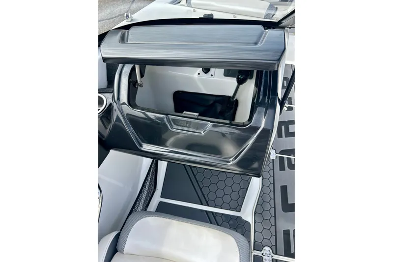Slide: The Image of Interior view of 2022 Scarab 215 ID boat, featuring storage compartment and seating. - 34