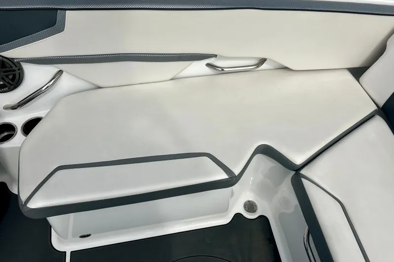 Slide: The Image of 2022 Scarab 215 ID boat interior seating with cup holders and speaker. - 24
