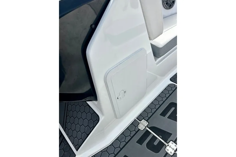 Slide: The Image of 2022 Scarab 215 ID boat interior with storage compartment and hexagonal flooring. - 54