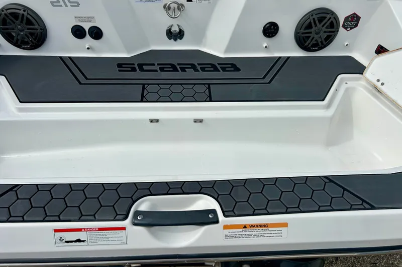 Slide: The Image of 2022 Scarab 215 ID boat deck with speakers and warning labels. - 17