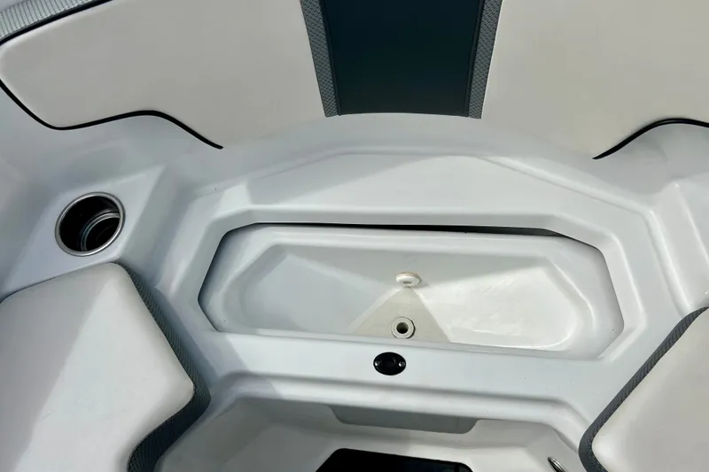 Slide: The Image of Interior view of a 2022 Scarab 215 ID boat, featuring sleek white seating. - 41