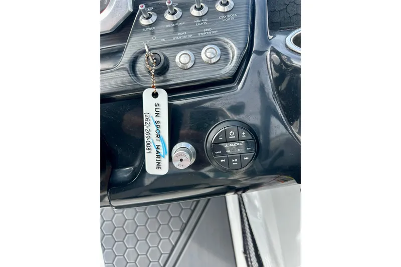 Slide: The Image of Dashboard of 2022 Scarab 215 ID boat with audio controls and keychain. - 27