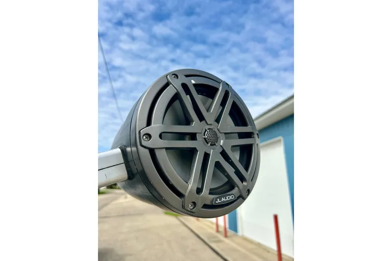 Slide: The Image of Close-up of JL Audio speaker on 2022 Scarab 215 ID boat, blue sky background. - 53