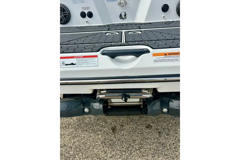 Slide: The Image of Rear view of 2022 Scarab 215 ID boat with warning labels and deck details. - 18