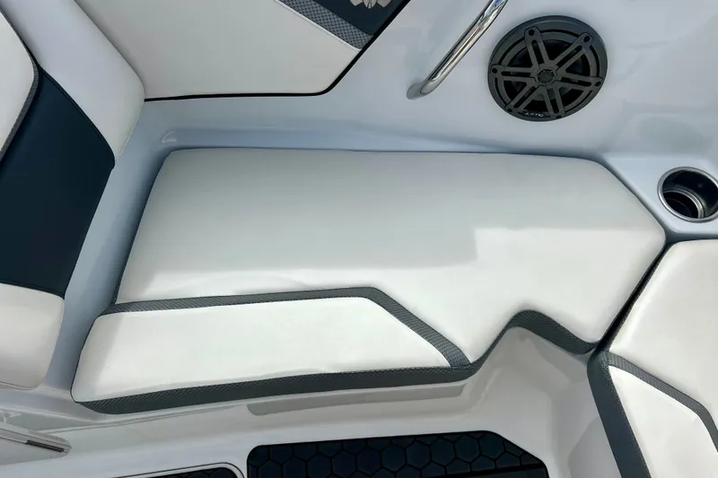 Slide: The Image of 2022 Scarab 215 ID boat interior with cushioned seating and speaker. - 38
