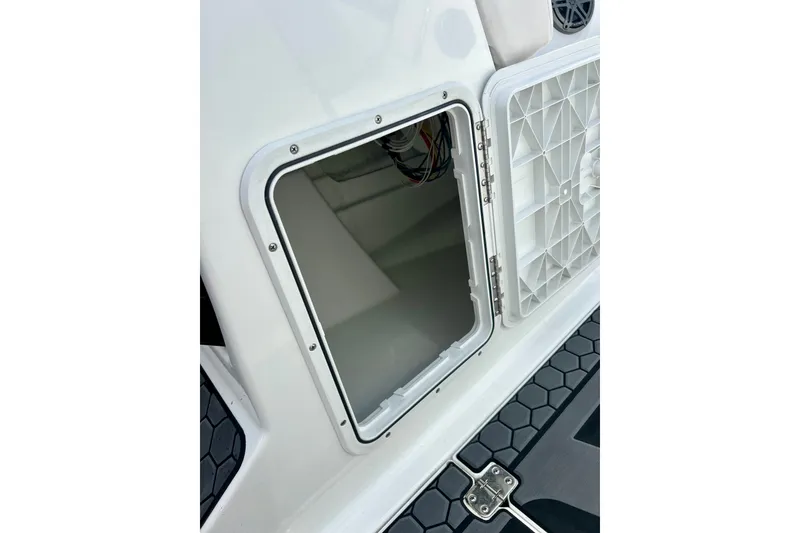 Slide: The Image of Open storage compartment on 2022 Scarab 215 ID boat, showcasing interior details. - 55