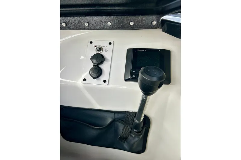 Slide: The Image of Control panel of 2022 Scarab 215 ID boat with switches and display. - 35