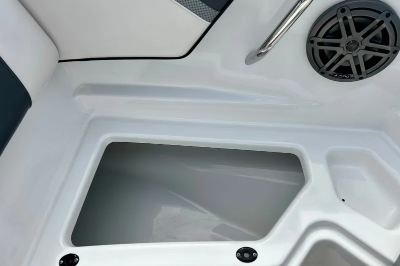Slide: The Image of Interior view of 2022 Scarab 215 ID boat, featuring storage compartment and speaker. - 39
