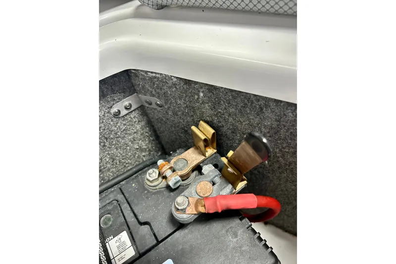 Slide: The Image of Battery terminal connections in a 2022 Scarab 215 ID boat. - 59