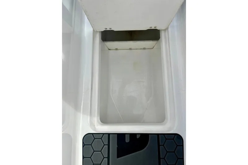 Slide: The Image of Interior compartment of 2022 Scarab 215 ID boat, featuring a clean, white storage area. - 45