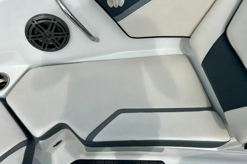 Slide: The Image of 2022 Scarab 215 ID boat interior with cushioned seating and speaker. - 42