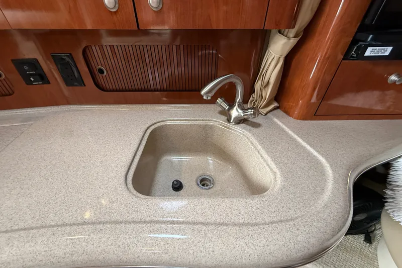 Slide: The Image of 2006 Sea Ray Sundancer 320 interior with sink and wooden cabinetry. - 34
