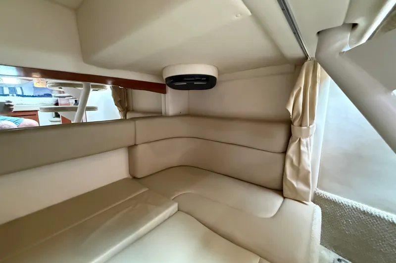 Slide: The Image of Interior cabin of 2006 Sea Ray Sundancer 320 with beige seating and wood accents. - 44