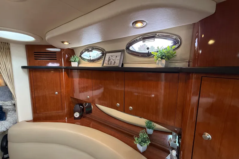 Slide: The Image of Luxurious interior of 2006 Sea Ray Sundancer 320 with wood cabinetry and porthole windows. - 27