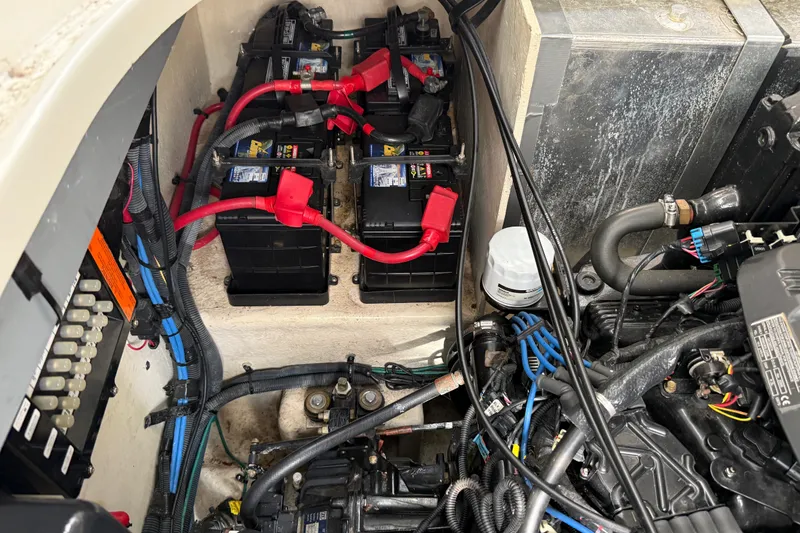 Slide: The Image of Engine compartment of a 2006 Sea Ray Sundancer 320, showing batteries and wiring. - 54