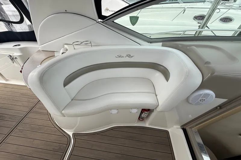Slide: The Image of Interior seating of a 2006 Sea Ray Sundancer 320 boat, featuring white cushioned seats. - 15