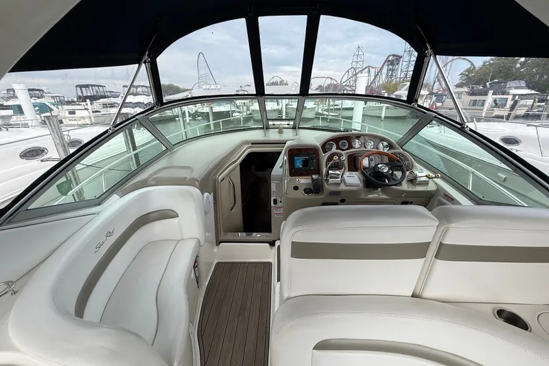 Slide: The Image of Interior view of a 2006 Sea Ray Sundancer 320 yacht cockpit with steering wheel and seating. - 13