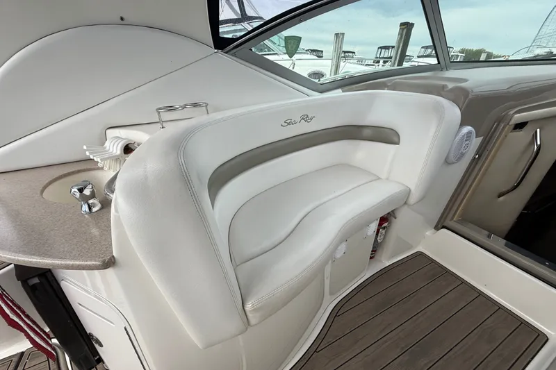 Slide: The Image of Interior of a 2006 Sea Ray Sundancer 320 boat with white seating and wood flooring. - 14