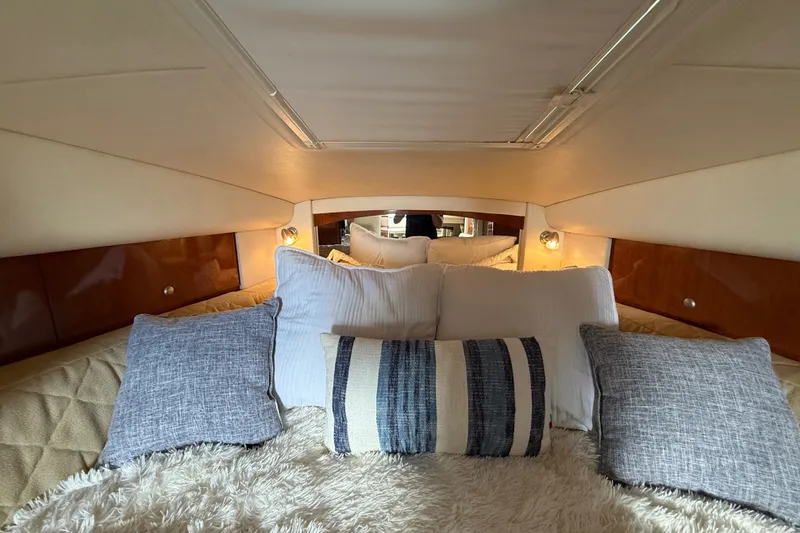 Slide: The Image of Luxurious cabin interior of 2006 Sea Ray Sundancer 320 with plush bedding and ambient lighting. - 38