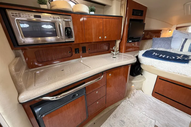 Slide: The Image of Luxurious 2006 Sea Ray Sundancer 320 interior with kitchenette and cozy sleeping area. - 29