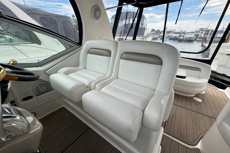 Slide: The Image of Interior of 2006 Sea Ray Sundancer 320 yacht with white leather seating and marina view. - 16