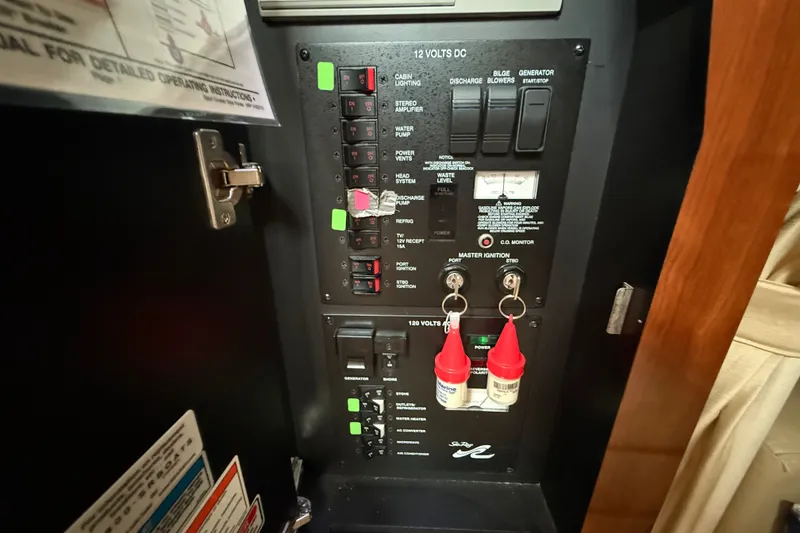 Slide: The Image of Electrical control panel of a 2006 Sea Ray Sundancer 320 boat, featuring switches and keys. - 49