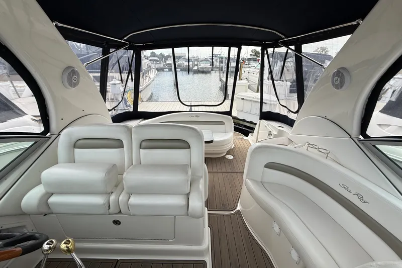 Slide: The Image of Interior view of a 2006 Sea Ray Sundancer 320 yacht with white seating and wood flooring. - 23