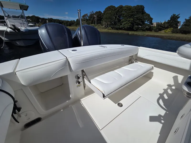 Slide: The Image of A 2020 Regulator 25 with white upholstery and twin outboard engines, on calm waters. - 13