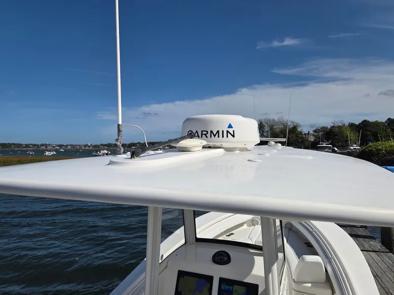 Slide: The Image of A 2020 Regulator 25 boat with Garmin equipment, on the water under sunny skies. - 7