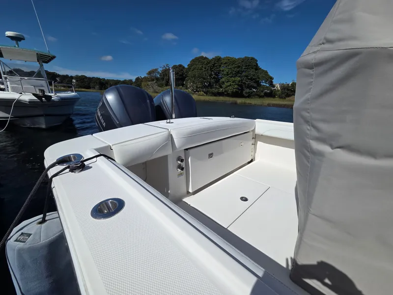 Slide: The Image of The image shows the stern of a 2020 Regulator 25 boat with twin outboard engines. - 12