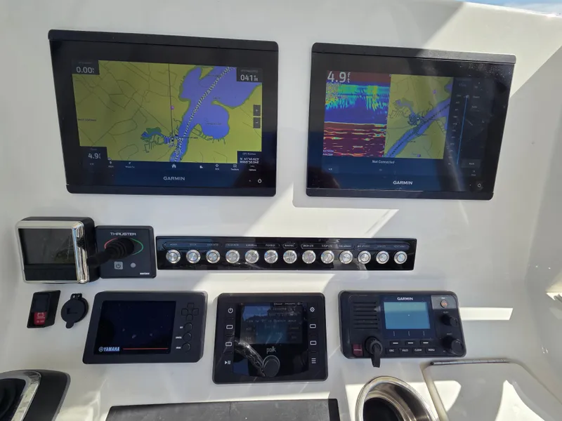 Slide: The Image of The image shows the dashboard of a 2020 Regulator 25 boat with multiple navigation screens and controls. - 10