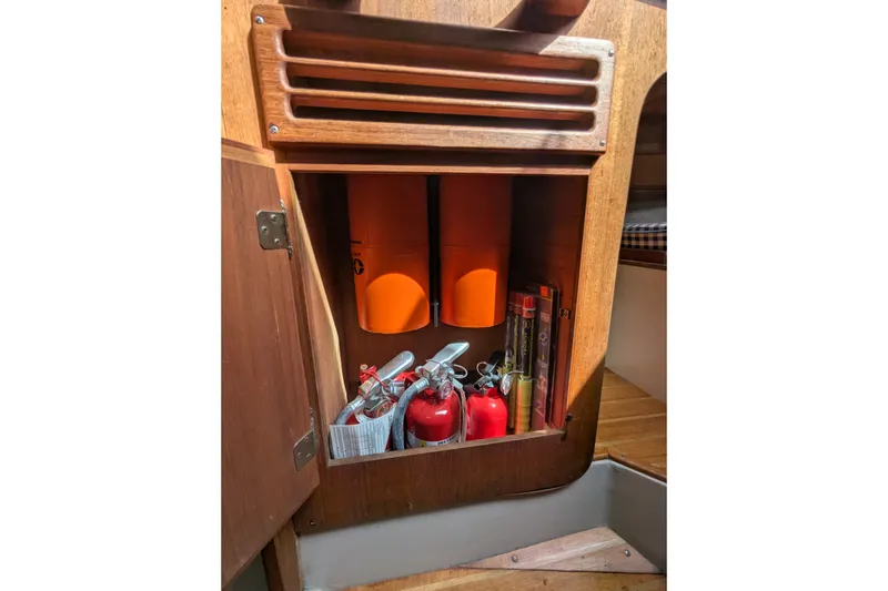 Slide: The Image of Wooden cabinet on 1980 Sceptre 36 yacht with safety equipment and fire extinguishers. - 21