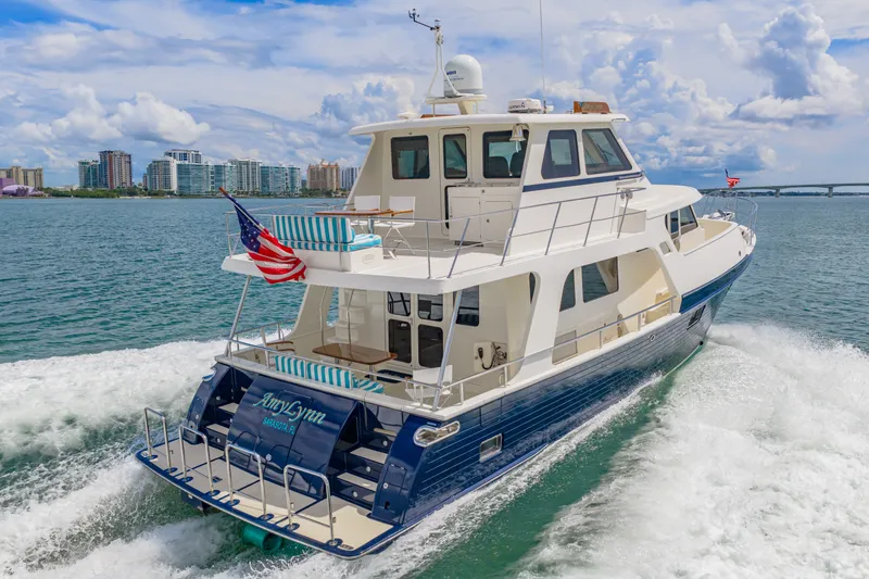 Slide: The Image of 2017 Marlow Explorer 49E yacht cruising near city skyline and bridge. - 1