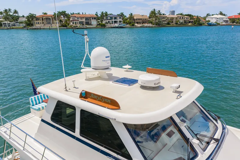 Slide: The Image of 2017 Marlow Explorer 49E yacht on water, luxury waterfront homes in background. - 22