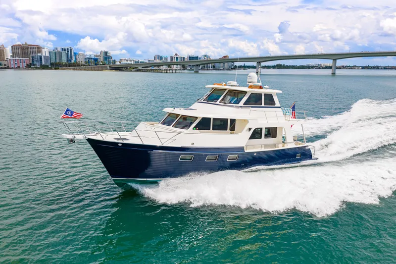 Slide: The Image of 2017 Marlow Explorer 49E yacht cruising near city skyline and bridge. - 21