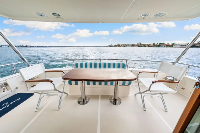 Slide: The Image of Aft deck of 2017 Marlow Explorer 49E yacht with seating and ocean view. - 17
