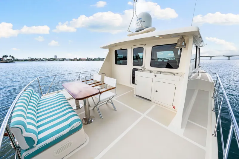 Slide: The Image of 2017 Marlow Explorer 49E yacht deck with seating, table, and ocean view. - 15